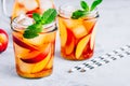 Homemade peach iced tea or lemonade with fresh mint and ice cubes in glass jar Royalty Free Stock Photo