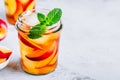 Homemade peach iced tea or lemonade with fresh mint and ice cubes in glass jar Royalty Free Stock Photo