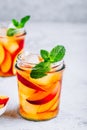 Homemade peach iced tea or lemonade with fresh mint and ice cubes in glass jar Royalty Free Stock Photo