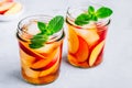 Homemade peach iced tea or lemonade with fresh mint and ice cubes in glass jar Royalty Free Stock Photo