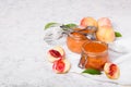 Homemade peach jam with organic fruit. Sweet preserves on a light background