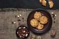Homemade peanut cookies on a brown plate with raw peanuts in background Royalty Free Stock Photo