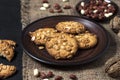 Homemade peanut cookies on a brown plate with raw peanuts in background Royalty Free Stock Photo