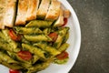 Penne pasta in pesto sauce with grilled chicken Royalty Free Stock Photo