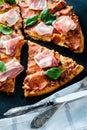 Homemade Pepperoni Pizza with fresh bacon over black background Royalty Free Stock Photo