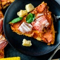 Homemade Pepperoni Pizza with fresh bacon over black background Royalty Free Stock Photo