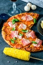 Homemade Pepperoni Pizza with fresh bacon over black background Royalty Free Stock Photo