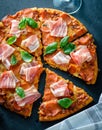 Homemade Pepperoni Pizza with fresh bacon over black background Royalty Free Stock Photo