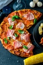 Homemade Pepperoni Pizza with fresh bacon over black background Royalty Free Stock Photo