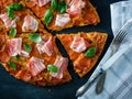 Homemade Pepperoni Pizza with fresh bacon over black background Royalty Free Stock Photo