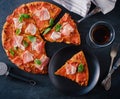 Homemade Pepperoni Pizza with fresh bacon over black background Royalty Free Stock Photo