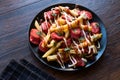 Homemade Peruvian Salchipapa Fries with Sausage Slices, Ketchup and Mayonnaise. Royalty Free Stock Photo