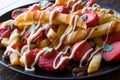 Homemade Peruvian Salchipapa Fries with Sausage Slices, Ketchup and Mayonnaise. Royalty Free Stock Photo