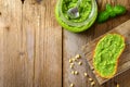 Homemade pesto sauce, bread. Ingredients. Cheese, garlic, basil, pine nuts, olive oil on an old wooden table. Royalty Free Stock Photo