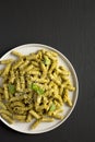 Homemade Pesto Twist Pasta on a plate on a black background, top view. Overhead, from above, flat lay Royalty Free Stock Photo