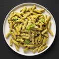 Homemade Pesto Twist Pasta on a plate on a black surface, top view. Overhead, from above, flat lay Royalty Free Stock Photo