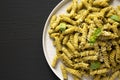 Homemade Pesto Twist Pasta on a plate on a black surface, top view. Overhead, from above, flat lay. Copy space Royalty Free Stock Photo