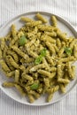 Homemade Pesto Twist Pasta on a plate on cloth, top view. Overhead, from above, flat lay Royalty Free Stock Photo