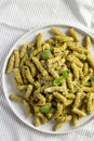 Homemade Pesto Twist Pasta on a plate on cloth, top view. Overhead, from above, flat lay. Close-up Royalty Free Stock Photo