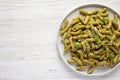 Homemade Pesto Twist Pasta on a plate on a white wooden background, top view. Overhead, from above, flat lay. Space for text Royalty Free Stock Photo