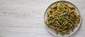 Homemade Pesto Twist Pasta on a plate on a white wooden surface, overhead view. Top view, from above, flat lay. Copy space Royalty Free Stock Photo