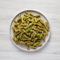 Homemade Pesto Twist Pasta on a plate on a white wooden table, overhead view. Top view, from above, flat lay Royalty Free Stock Photo