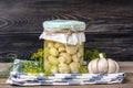 Homemade pickled champignons, garlic in jars on wooden shelf Homemade canned and fermented foods concept Seasonal product Royalty Free Stock Photo