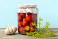 Homemade pickled cherry tomatoes, cucumbers, champignons, garlic, eggplant, red peppers in jars on wooden shelf Homemade canned Royalty Free Stock Photo