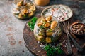 Homemade pickled mushrooms in a jar with spices