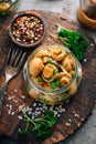 Homemade pickled mushrooms in a jar with spices