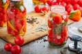 Homemade pickled tomatoes in jar. Selective focus.