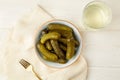 Marinated gherkins in a bowl and pickled juice or cucumber pickle Royalty Free Stock Photo