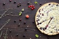 Homemade pie with berries on wooden table texture. Summer receipts