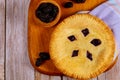 Homemade pie with blackberries on wooden background. Top view