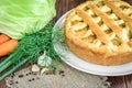 Homemade pie with cabbage, carrot, onion and meat on wooden background Royalty Free Stock Photo