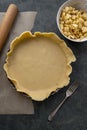 Homemade pie crust in pie plate. Cooking apple pie, dark background Royalty Free Stock Photo