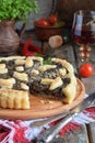Homemade pie with mushrooms and herbs. Quiche on wooden background. Vegetarian food.
