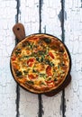 Homemade pie ( quiche) with spinach, tomatoes and soft cheese