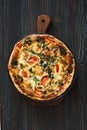 Homemade pie ( quiche) with spinach, tomatoes and soft cheese