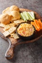 Homemade Pimento Cheese Spread with Crackers and Veggies closeup on the wooden board. Vertical