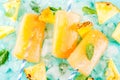 Homemade Pineapple Popsicles on Ice with fresh Pineapple slices