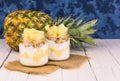 Two jars of homemade pineapple yogurt. A concept of light and healthy desserts.