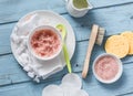 Homemade pink himalayan salt and coconut oil body scrub on a blue background, top view. Beauty, skin care concept