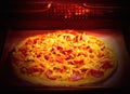 Homemade pizza baking in the electric oven. Soft focus Royalty Free Stock Photo