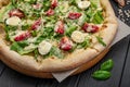 Homemade pizza with Caesar salad, an interesting serving of salad with chicken meat