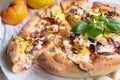 Homemade pizza with feta cheese, salami, yellow squash, onions and tomatoes Royalty Free Stock Photo