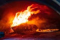 Homemade: pizza in a hot wood burning oven. Royalty Free Stock Photo