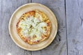 Homemade pizza or Italian Pizza in chopping board on a wooden table. top view, copy space Royalty Free Stock Photo