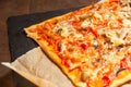 Homemade pizza with paprika, chicken meat and artichoke on the table Royalty Free Stock Photo