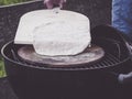 Homemade pizza place the crust on a pizza stone